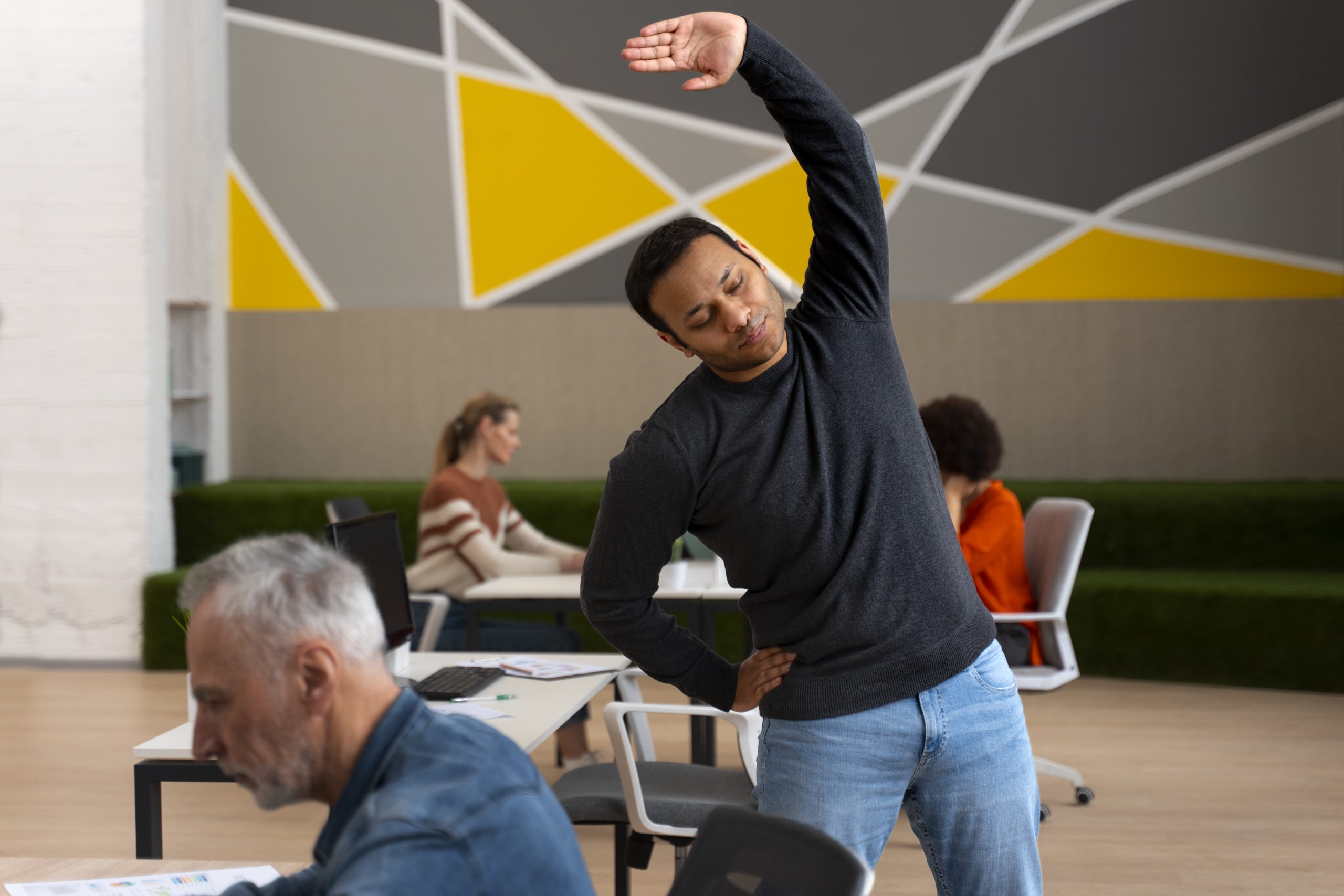 man-office-stretching-work-day